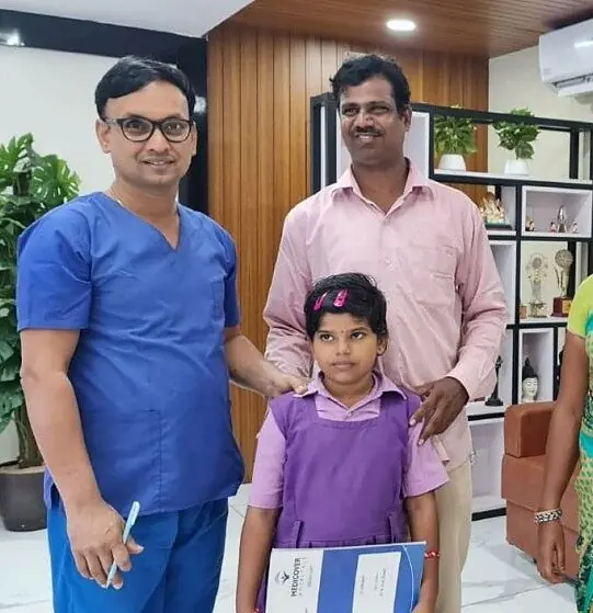 Dr. Sridhar with a father and his daughter at the hospital