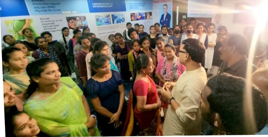 Students gathered around Dr. Sridhar at the hospital for the free HPV vaccination programme